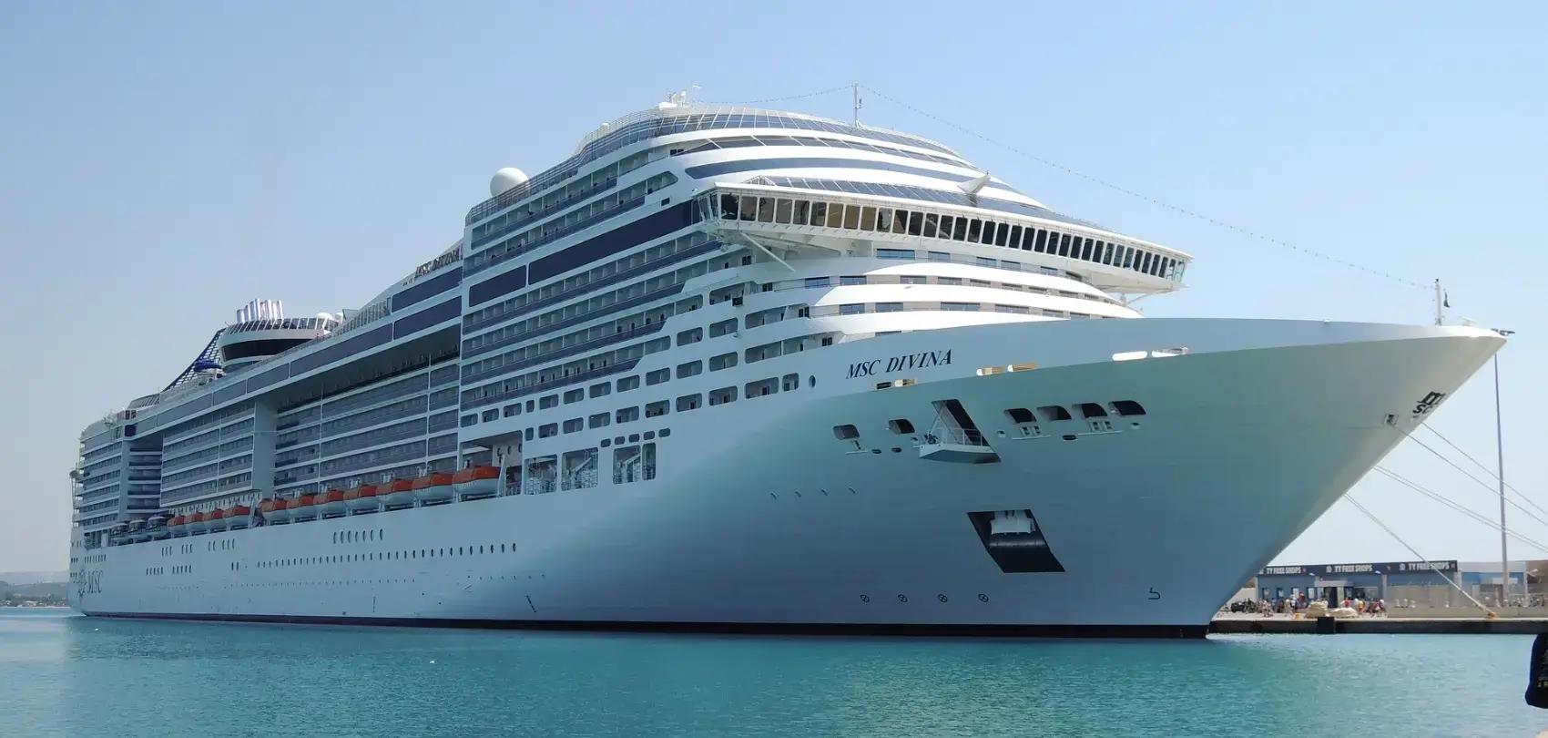 large MSC Divina cruise ship docked in a harbor