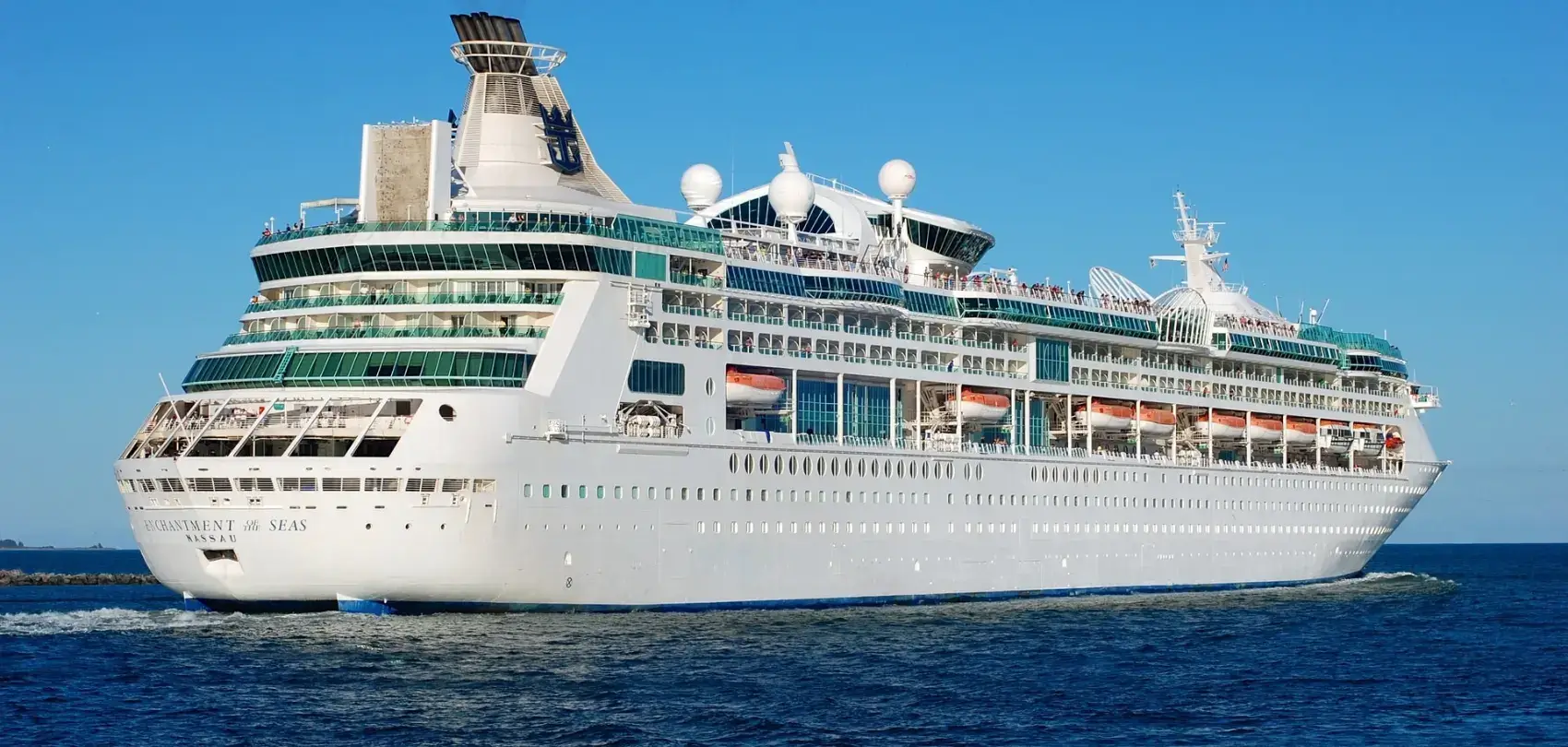 A large cruise ship floating on a blue ocean